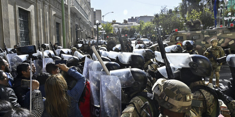 Military troops are deployed outside the Quemado Palace at the Plaza de Armas in La Paz on June 26, 2024. Bolivian President Luis Arce on Wednesday denounced the unauthorized gathering of soldiers and tanks outside government buildings in the capital La Paz, saying "democracy must be respected." "We denounce irregular mobilizations by some units of the Bolivian Army," Arce wrote on the X social network. Former president Evo Morales wrote on the same medium that "a coup d'Ètat is brewing." (Photo by AIZAR RALDES / AFP)